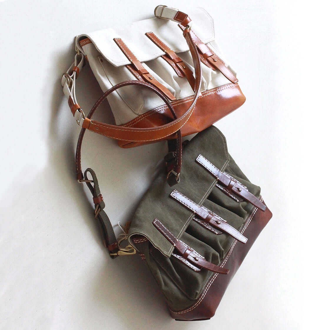 Canvas Leather Messenger Bag in three colors: beige, brown, and olive green stacked together.