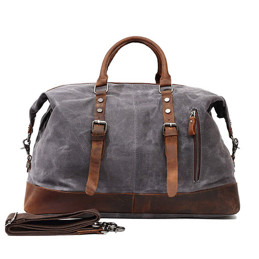 Large Waxed Canvas Travel Duffel Bag Leather Travel Duffle Luggage in gray with brown leather accents and adjustable shoulder strap.
