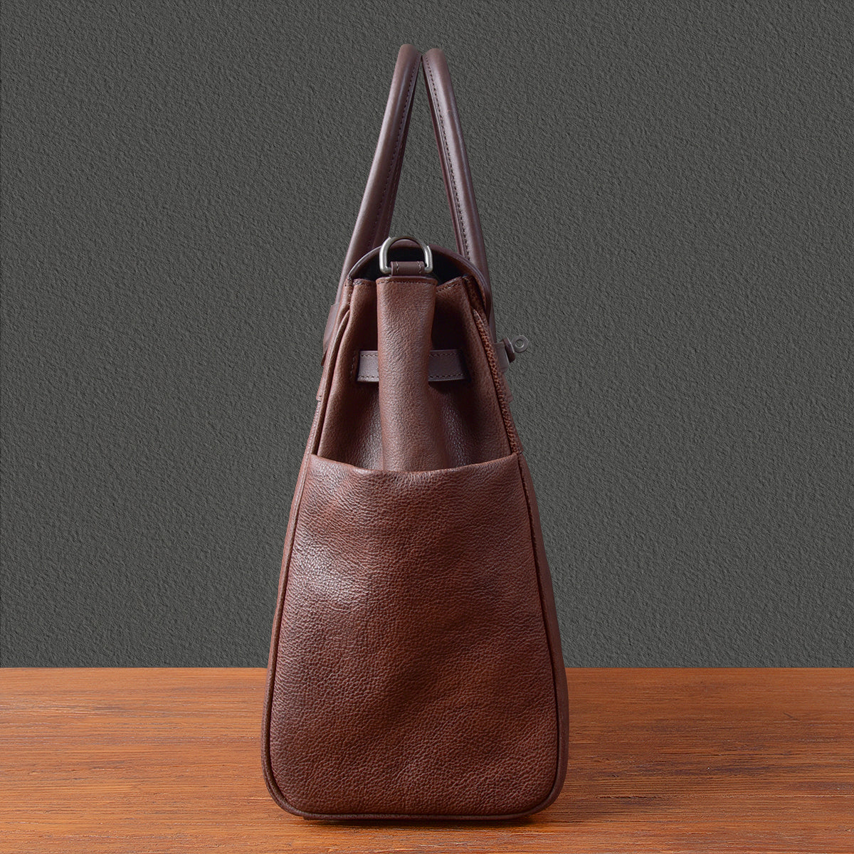 Mens leather work bag in brown, showcasing its smooth texture and practical design for business use.