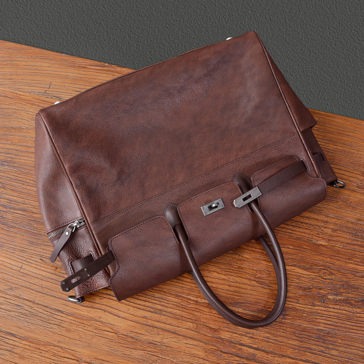 Men's brown leather work bag with zippers and handles, ideal for business and everyday use.