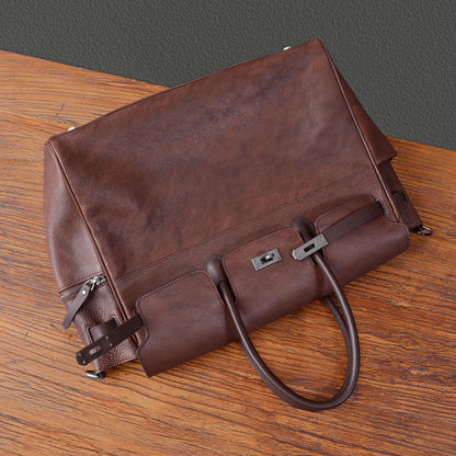 Men's brown leather work bag with zippers and handles, ideal for business and everyday use.