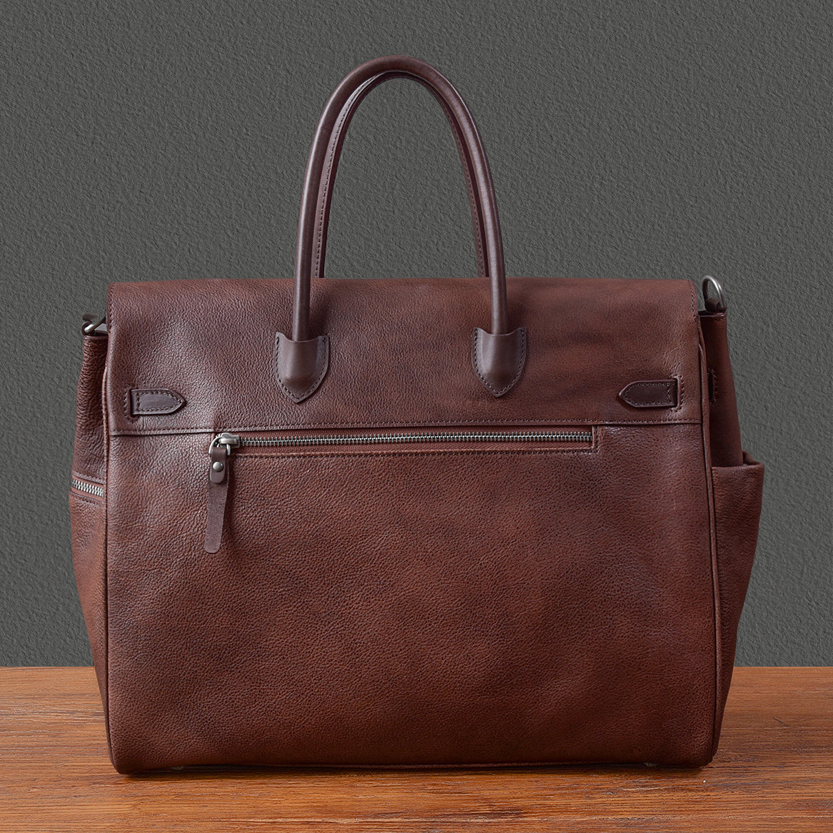 Brown leather men's work tote bag with dual handles and zippered pocket, ideal for business use.