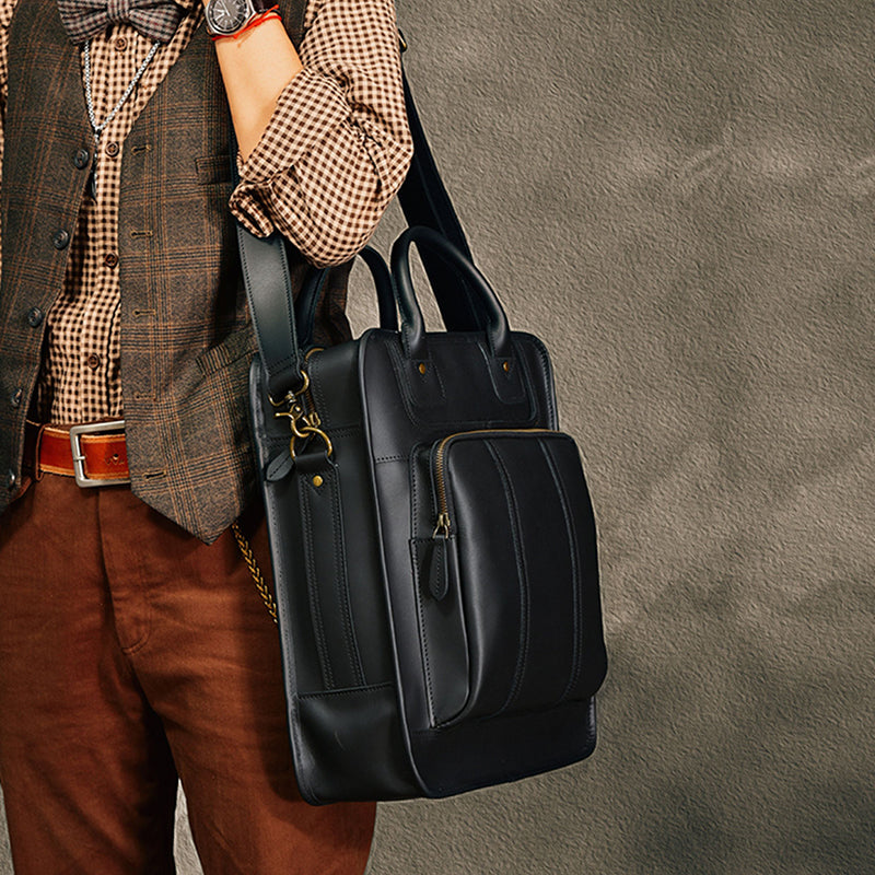 Stylish black leather laptop bag, worn by a man in a plaid shirt and vest, showcasing its modern design and utility.