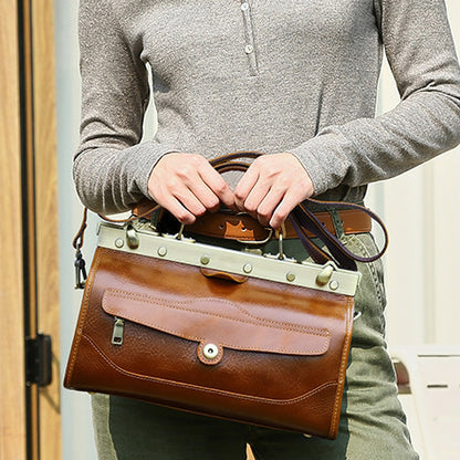 Woman holding a tan leather handbag with silver accents, showcasing a stylish crossbody design and practical dimensions.