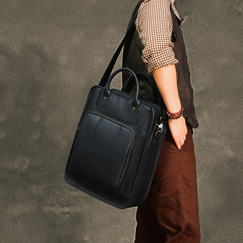 Stylish black leather laptop bag with shoulder strap carried by a man in casual attire.