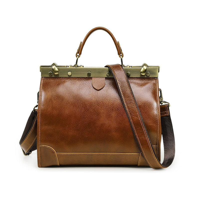 Brown leather crossbody bag with shoulder strap and brass accents, stylish and functional design.