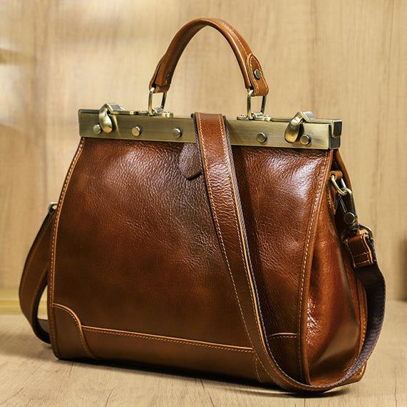 Stylish brown leather crossbody bag with brass hardware and adjustable strap.