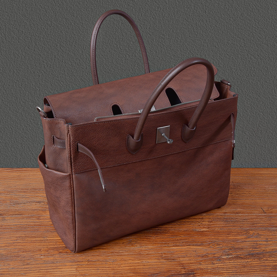 Brown leather work bag with two handles and front pocket, ideal for business use, dimensions 15x12.6x6.3 inches.
