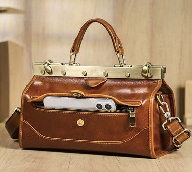 Genuine leather handbag for women in tan with a phone in the front pocket, showcasing stylish design and durable materials.