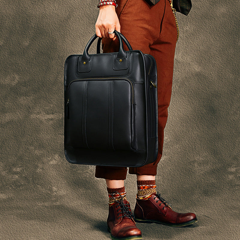 Stylish black leather laptop bag held by a person, perfect for 15-inch laptops, blending fashion and functionality.