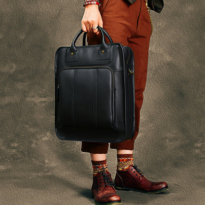Stylish black leather laptop bag held by a person, perfect for 15-inch laptops, blending fashion and functionality.