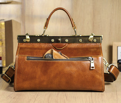 Genuine leather tan handbag for women with front zipper pocket and top handle, perfect for everyday use.