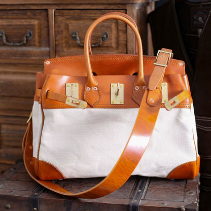 Canvas And Leather Handbags in a stylish design with a tan leather strap and gold hardware, perfect for work or casual use.