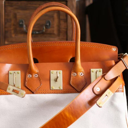 Canvas And Leather Handbags featuring a stylish work bag design with leather handles and a canvas body.