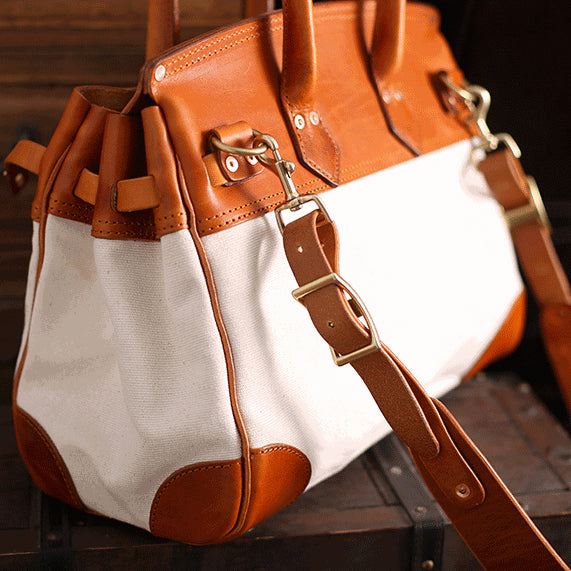 Canvas And Leather Handbags in unisex design, featuring sturdy leather straps and a practical work bag style.