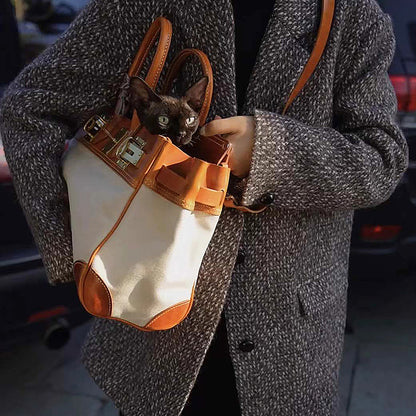Canvas And Leather Handbags with a stylish design, featuring a cat peeking out from a purse carried by a person.