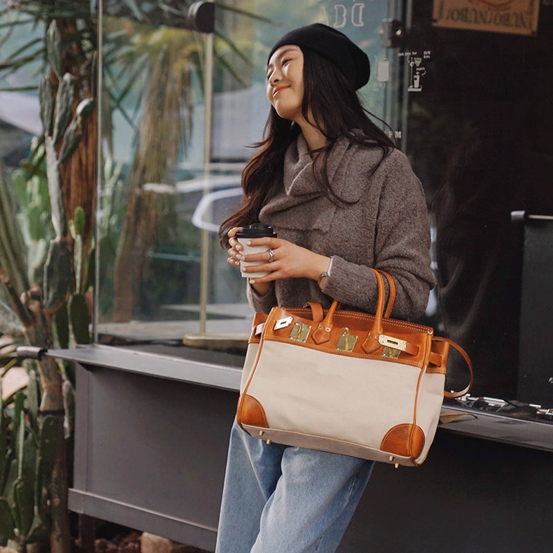 Canvas And Leather Handbags being carried by a woman in a cozy outfit, featuring a stylish work bag design.