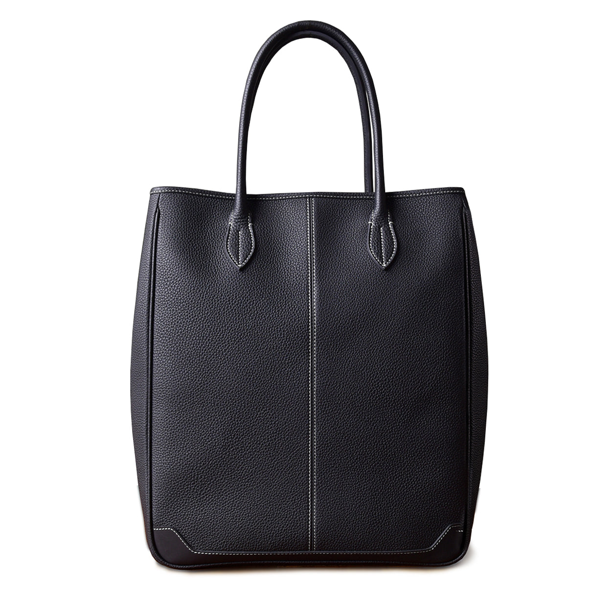 Large vertical black cowhide tote bag made of top-grain leather, ideal for laptops and everyday use.