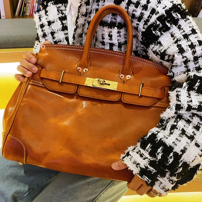 Leather Large Tote Bag being held by a person in a stylish outfit, showcasing its classic design and elegant details.