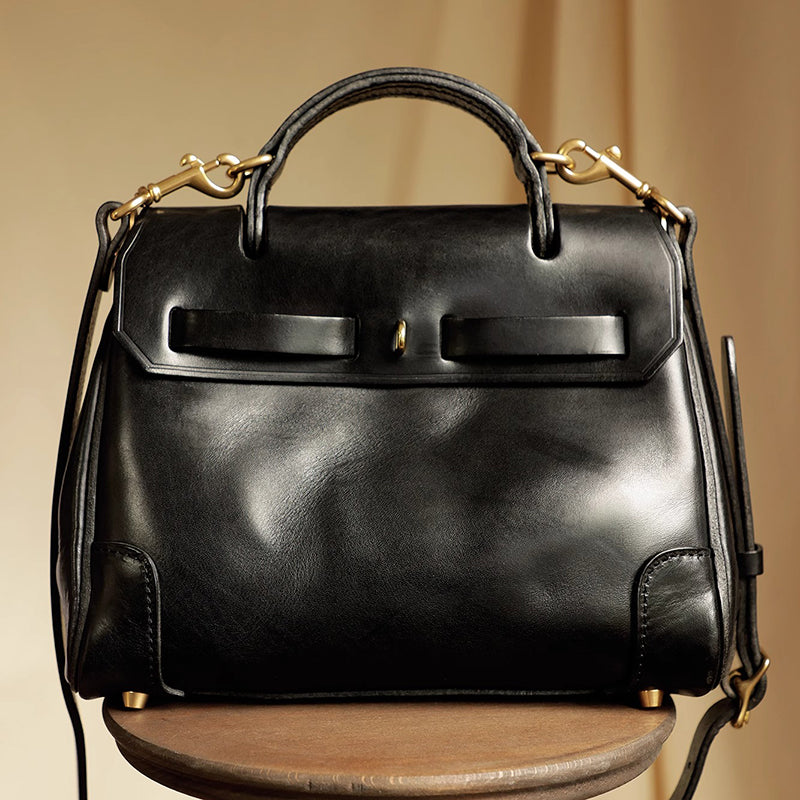 Classic Leather Bag in black leather with structured design, featuring dual handles and a detachable strap.