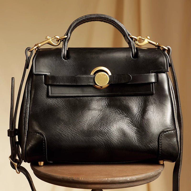 Classic Leather Bag in black with gold hardware on a wooden table.