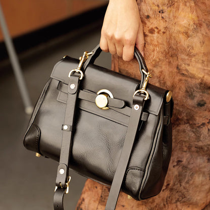 Classic Leather Bag being held, featuring a sleek design and gold hardware, perfect for stylish everyday use.