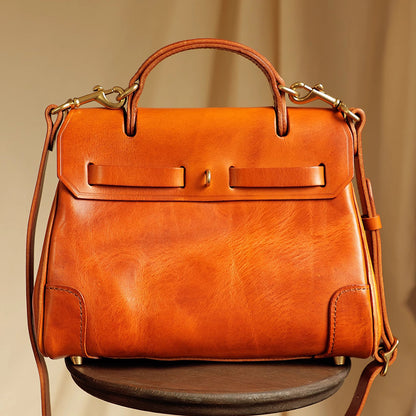 Classic Leather Bag - Elegant orange leather crossbody bag with top handles and detachable strap.