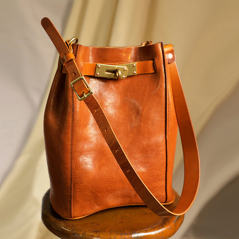Classic Italian Leather Bucket Bag Women in rich brown color with gold hardware and adjustable strap.
