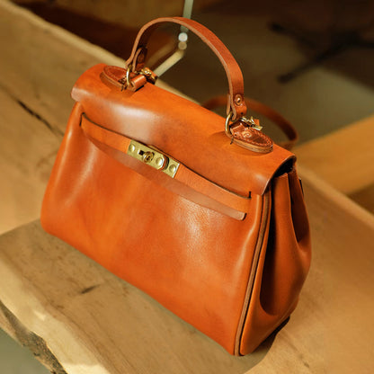 Handmade Italian Leather Tote Bag Women 11.8in artisan crossbody handbag in rich orange leather on wooden surface.