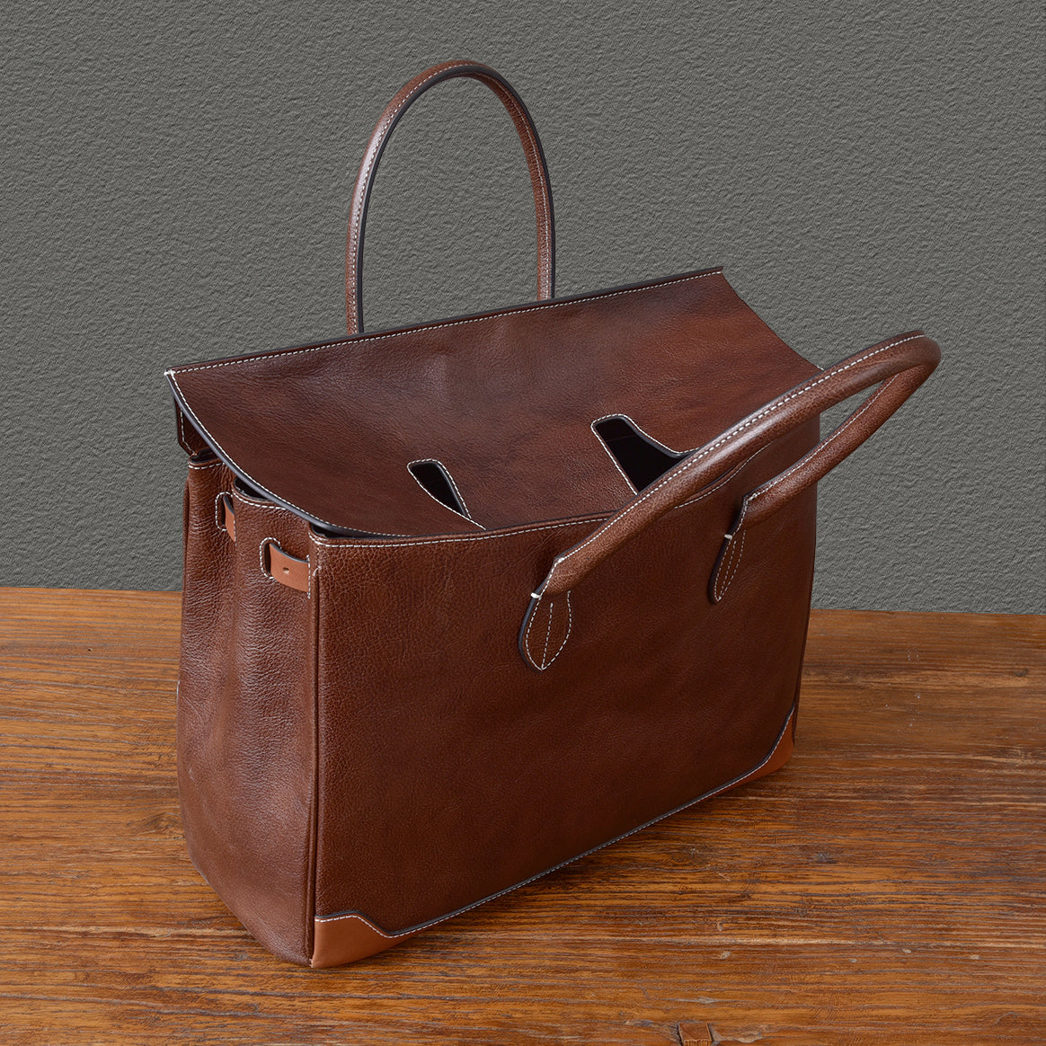 Brown top-grain leather large business tote bag with handles, ideal for laptops, measuring 15.7 x 12.6 x 6.3 inches.