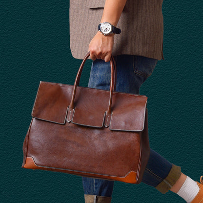 Brown top-grain leather large business tote bag held by a person wearing a watch, stylish and functional for professionals.