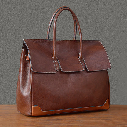 Large top-grain leather business tote bag in brown with double handles and stylish flap design.