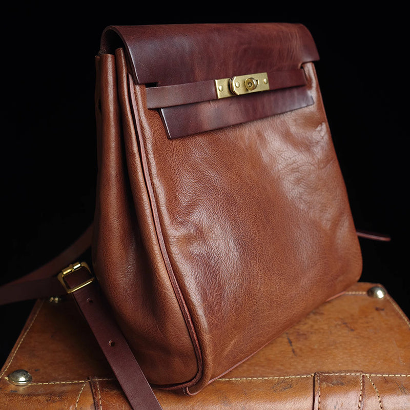 Leather Backpack Women in rich brown vegetable tanned leather with a stylish closure and adjustable strap.