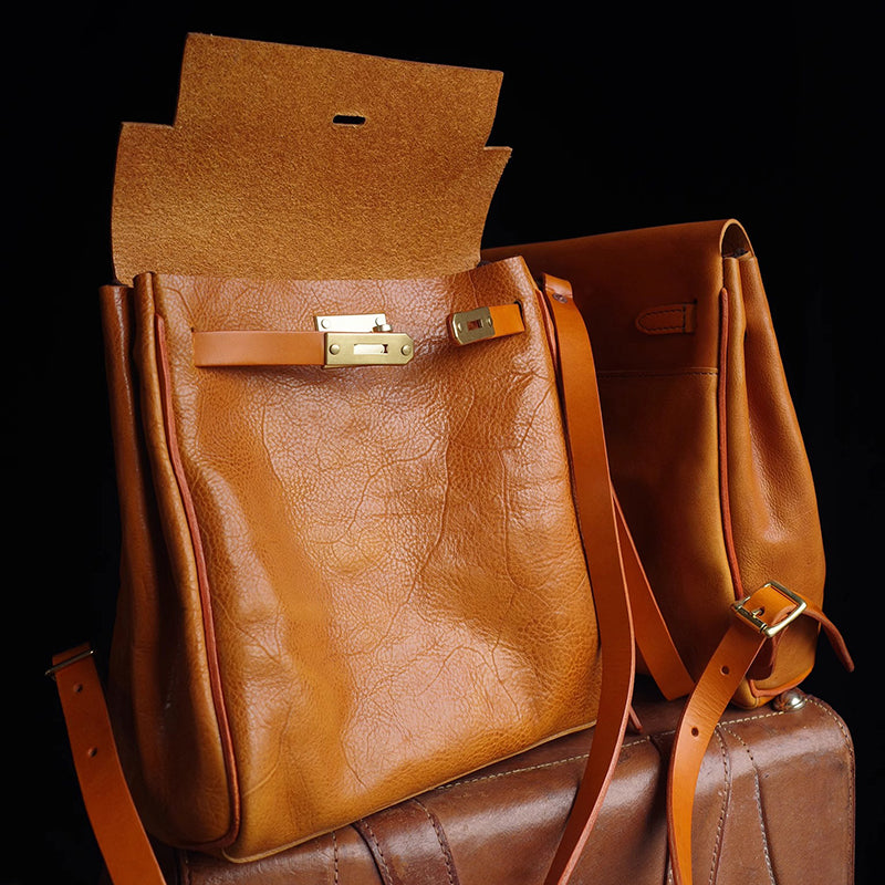 Leather Backpack Women in warm brown color with unique closure, showcasing stylish design and craftsmanship.