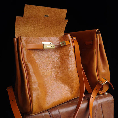 Leather Backpack Women in warm brown color with unique closure, showcasing stylish design and craftsmanship.