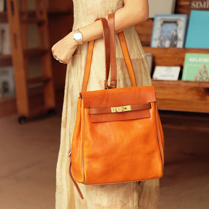 Stylish Vegetable Tanned Leather Backpack Women Small Rucksack 11.0in featuring a vibrant orange color and comfortable shoulder straps.