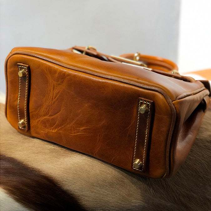 Bottom view of a Handcrafted Italian Leather Crossbody Bag Women showcasing its sturdy construction and rich brown leather.