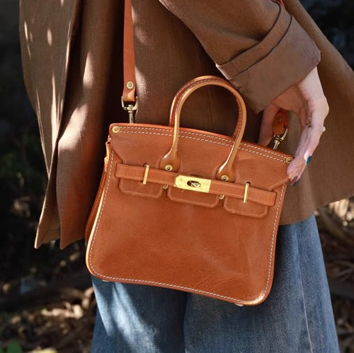 Classic Italian Leather Crossbody Bag Women shown in tan color, held by a model wearing a stylish outfit.