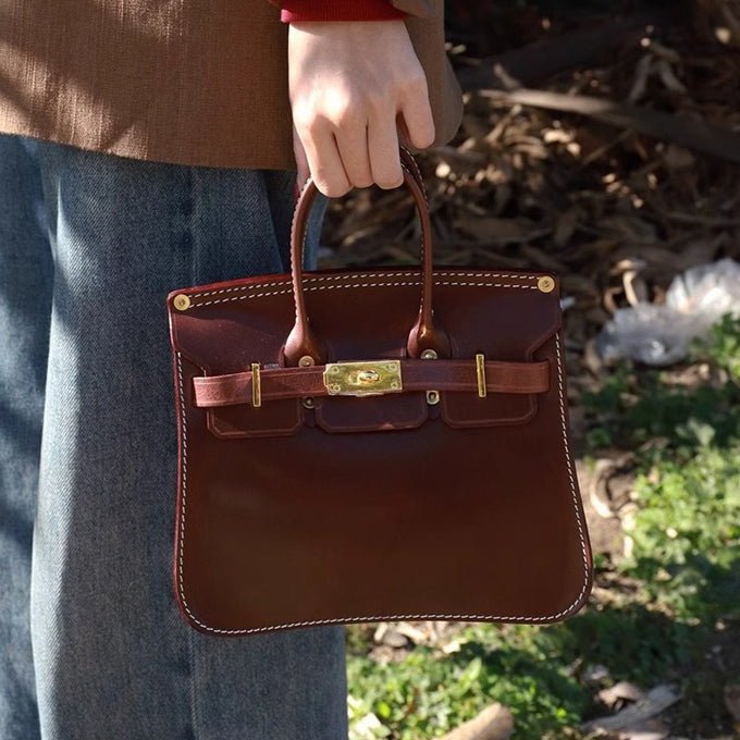 Woman holding a stylish Italian Leather Crossbody Bag Women in brown, showcasing premium craftsmanship and design.