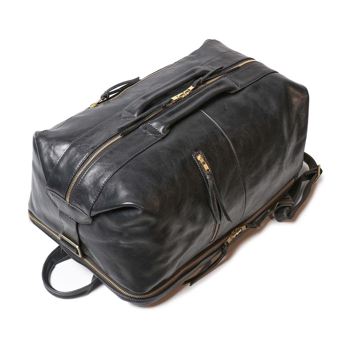 Top view of an 18-inch black full-grain leather laptop backpack with gold zippers, reinforced handles, and leather straps.