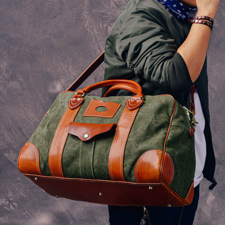 Canvas Duffle Bag Italian Leather Large Weekender Bag carried by a traveler showcasing its stylish design.