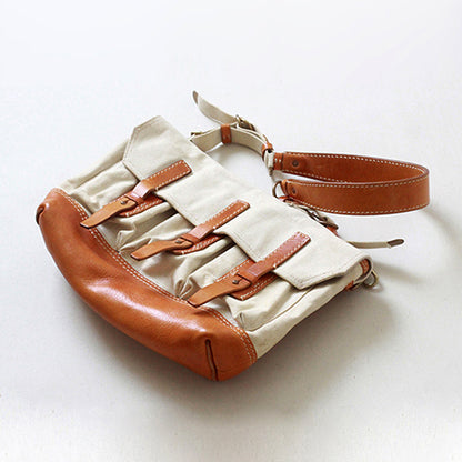 Canvas Leather Messenger Bag featuring leather trim and buckle closures, a stylish vintage flap design for crossbody use.