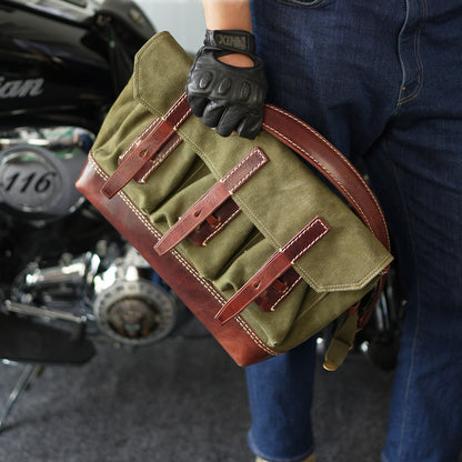 Canvas Leather Messenger Bag being carried by a person with gloves, showcasing a vintage design and multiple pockets.