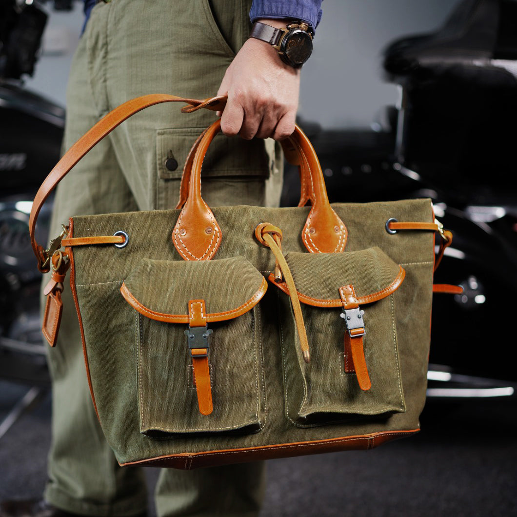 Large Canvas Leather Tote Bag held by a person with pockets, showcasing a vintage style and sturdy design.
