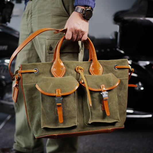 Large Canvas Leather Tote Bag held by a person with pockets, showcasing a vintage style and sturdy design.