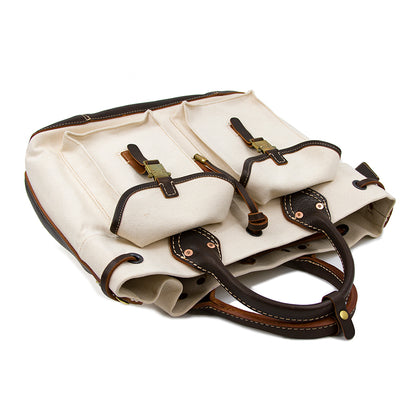 Large Canvas Leather Tote Bag with dual pockets and brown leather handles, showcasing a vintage style.