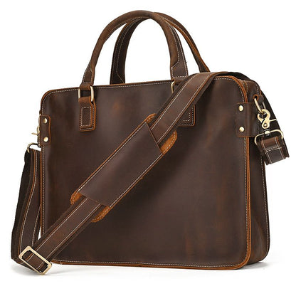 Full-grain leather 15" laptop briefcase with brass hardware, top handles, and adjustable padded shoulder strap.