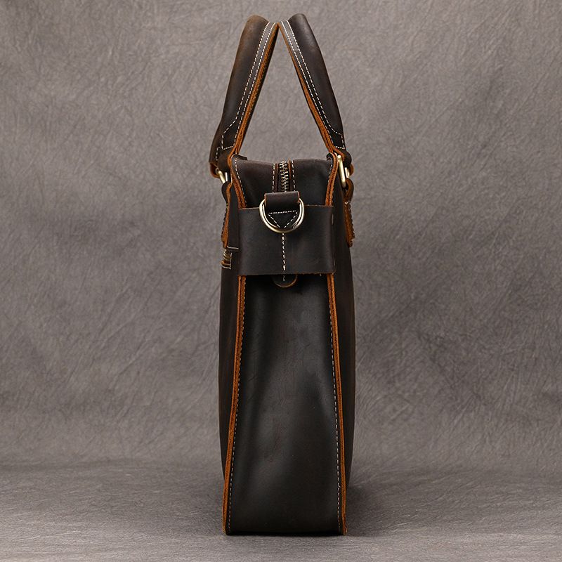 Side profile of a dark brown full-grain leather laptop briefcase featuring brass hardware and reinforced white stitching.