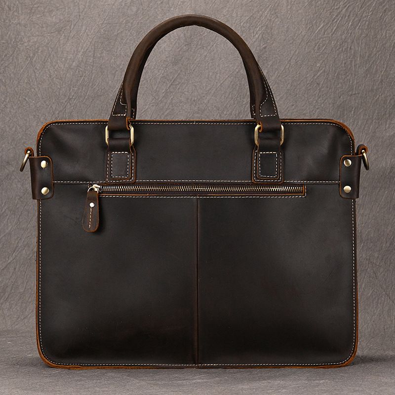 Full-grain dark brown leather briefcase for 15 inch laptop with front zipper pocket and brass hardware.
