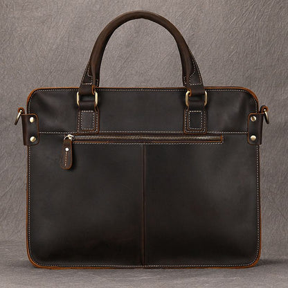 Full-grain dark brown leather briefcase for 15 inch laptop with front zipper pocket and brass hardware.